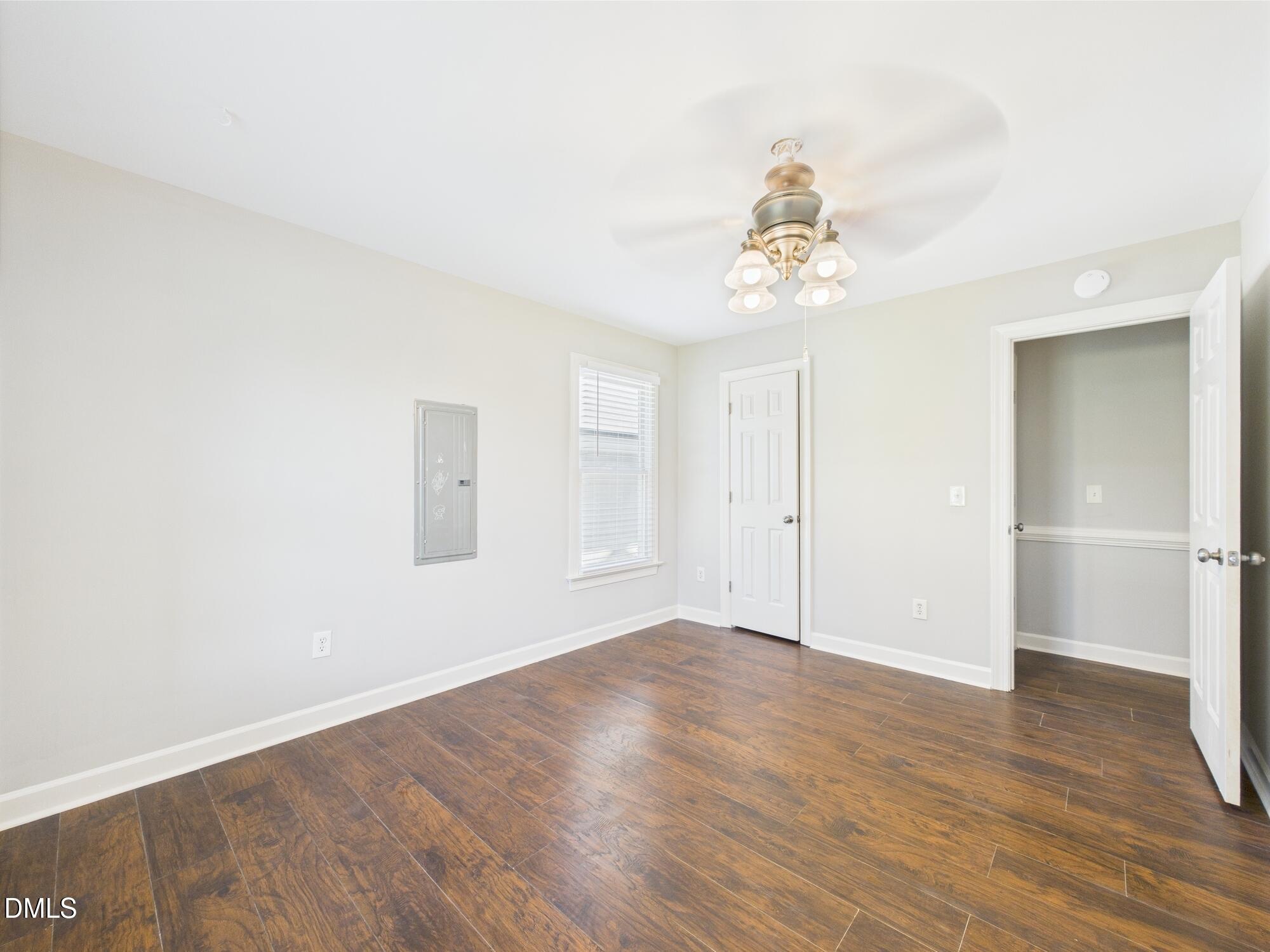 10917 Fanny Brown Road Raleigh, NC 27603 - Photo 32 of 54 an empty room with wooden floor chandelier fan and windows