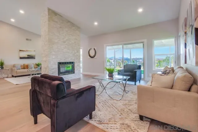 a living room with furniture and kitchen view