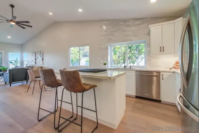 a bed sitting in a spacious bedroom next to a window