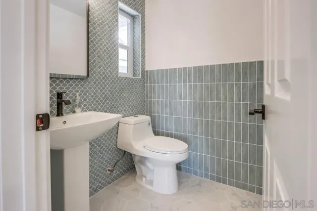 a bathroom with double vanity sink two mirror and a shower
