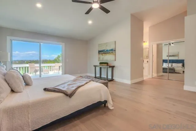 a view of a deck with wooden floor and fence with a bench
