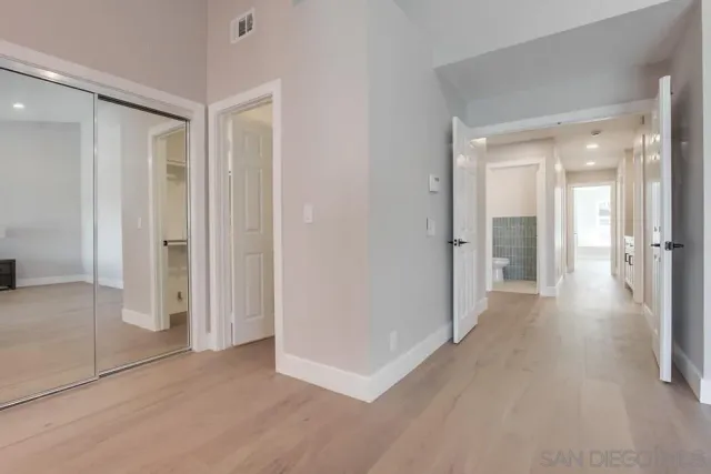 a bedroom with a large bed and a large window