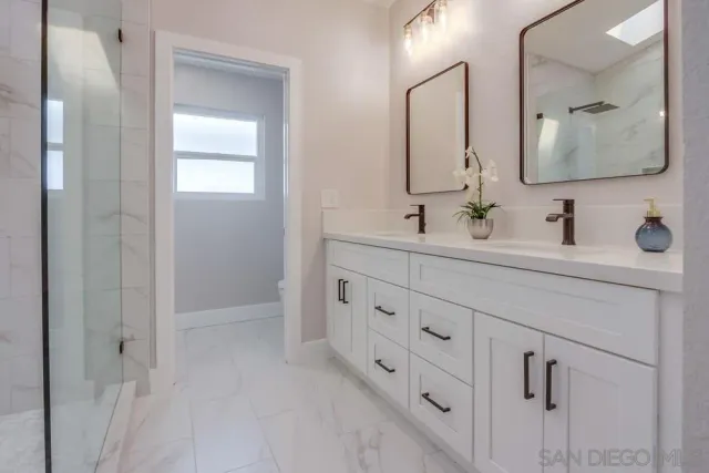 a spacious bedroom with a large bed and a chandelier fan