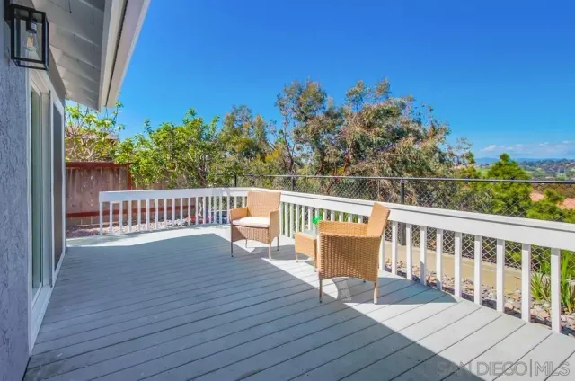 a view of an empty room with a chandelier fan