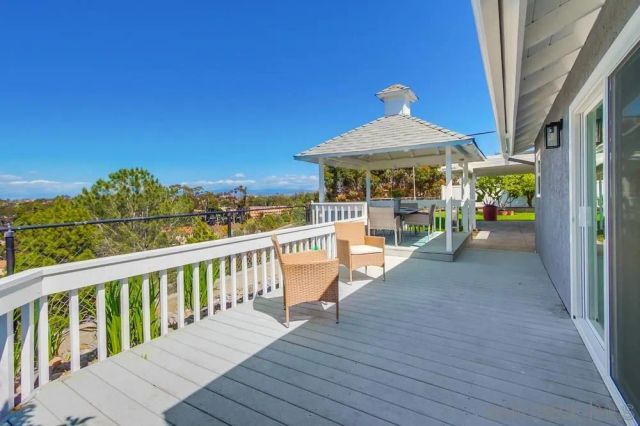an empty room with a window and a ceiling fan