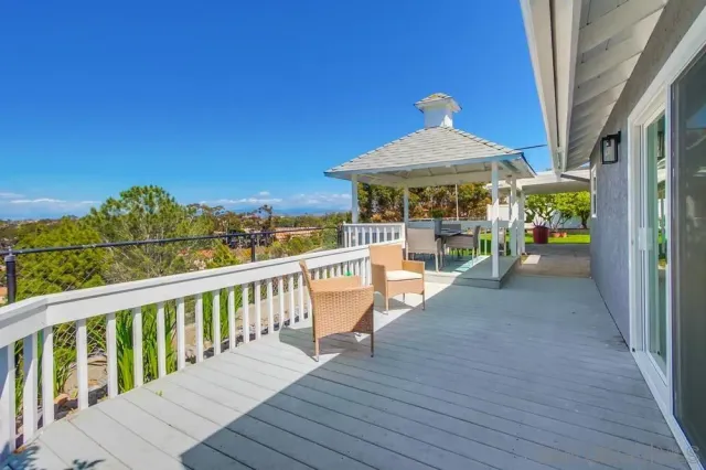 an empty room with a window and a ceiling fan