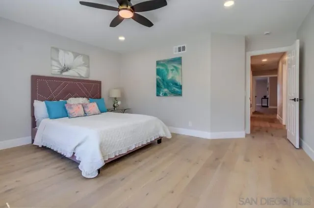 a view of a roof deck with table and chairs under an umbrella