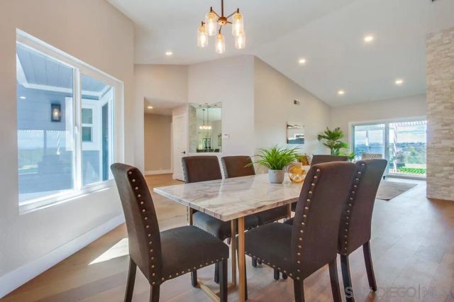 a view of a dining room with furniture and chandelier