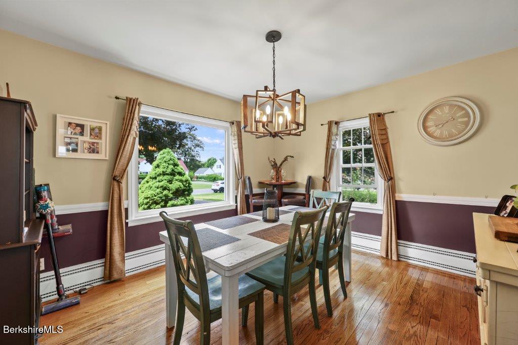33 Eleanor Road Pittsfield, MA 01201 - Photo 10 of 45 a dining room with furniture a chandelier and wooden floor