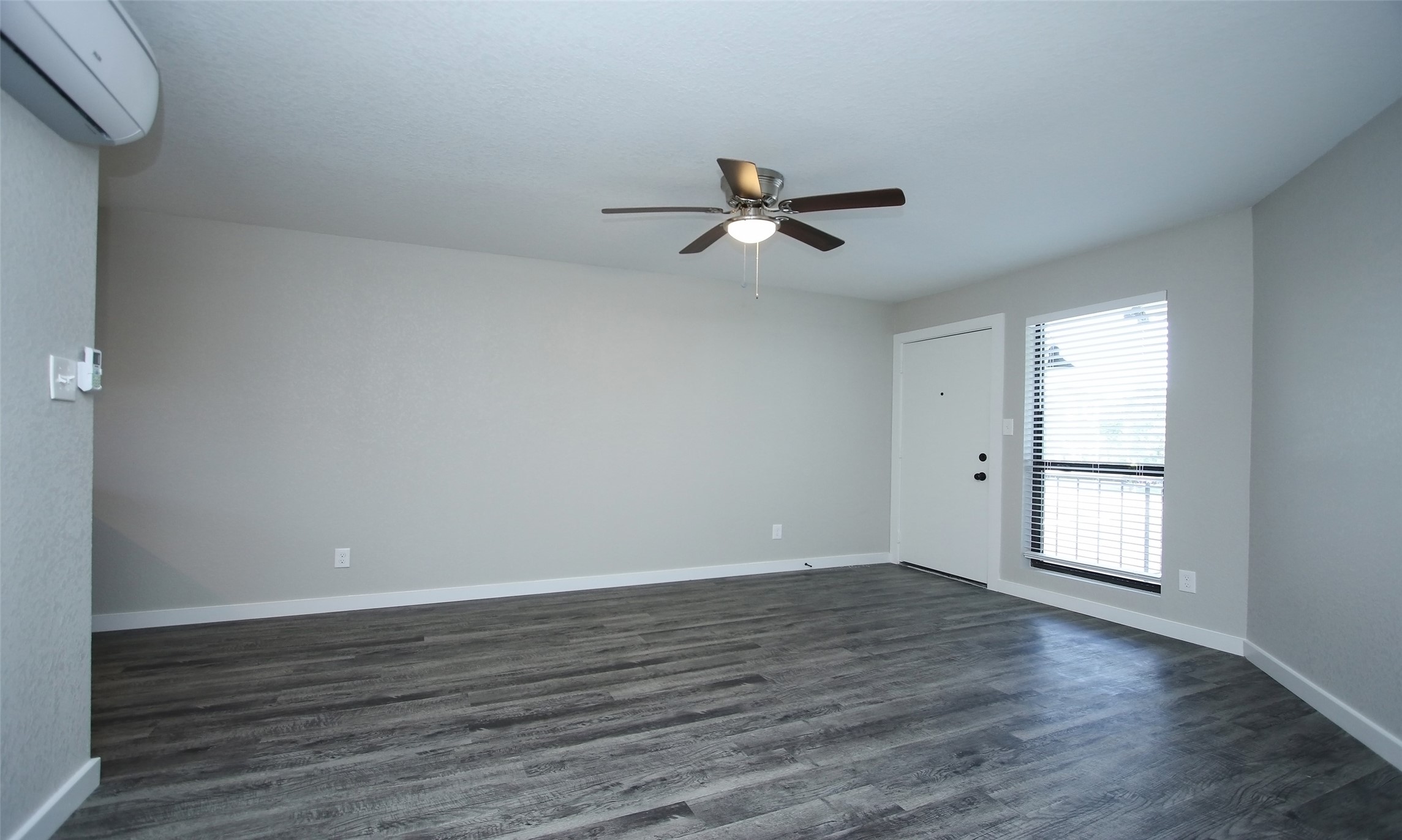 5201 Crawford Street, Unit 5 Houston, TX 77004 - Photo 5 of 10 a view of empty room with wooden floor and fan