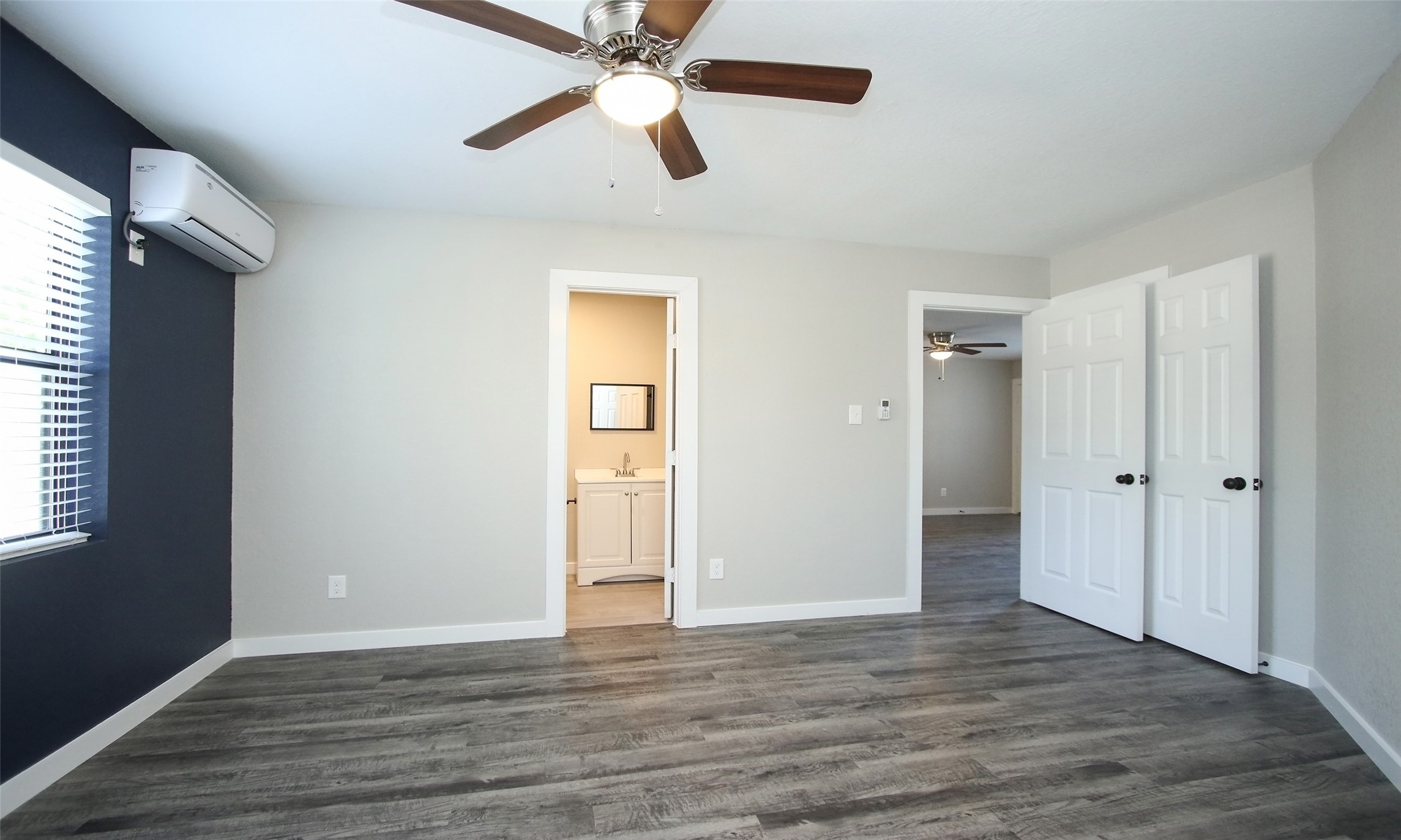 5201 Crawford Street, Unit 5 Houston, TX 77004 - Photo 7 of 10 an empty room with wooden floor closet and windows