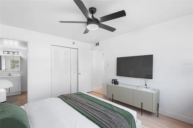 a bedroom with a bed and a flat screen tv