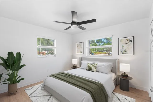 a bedroom with a bed and a potted plant