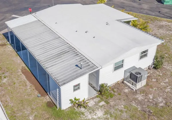 an aerial view of a house with a yard