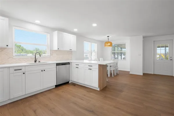 a kitchen with a refrigerator and a sink