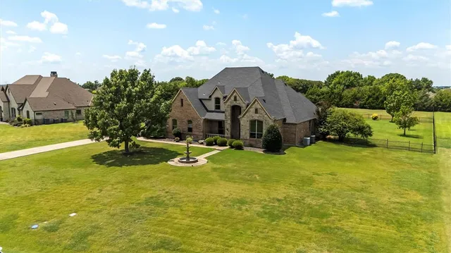 a view of a house with a yard and garage