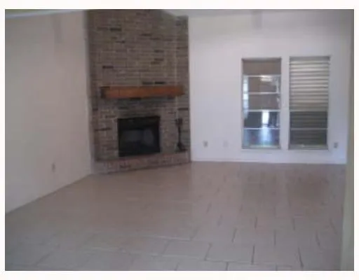 a view of an empty room with a fireplace