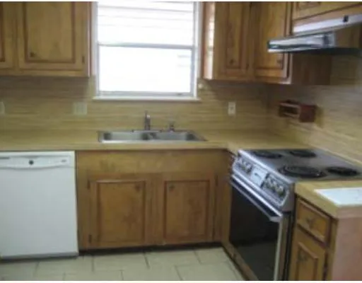 a kitchen with a sink stove and cabinets