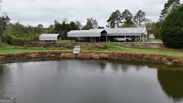 an aerial view of a house with swimming pool and outdoor space
