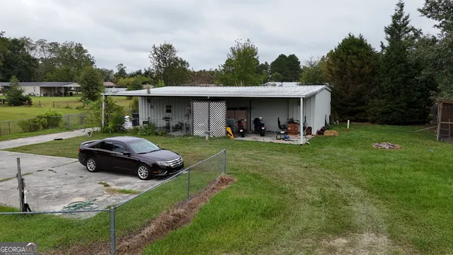a car parked in front of a house with a yard