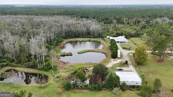 an aerial view of a house with pool yard and outdoor seating