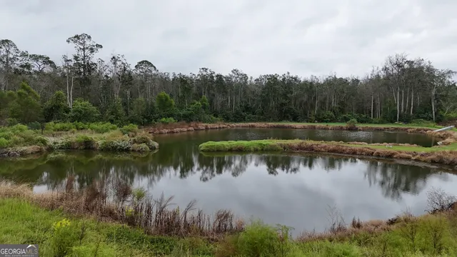 a view of a lake with green space
