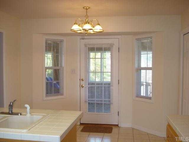 5845 Covered Bridge Road Clayton, NC 27527 - Photo 6 of 11 CERAMIC TILE floors continue on into this BREAKFAST Room with a BAY area and a door that accesses the SPACIOUS SCREENED-IN back porch!
