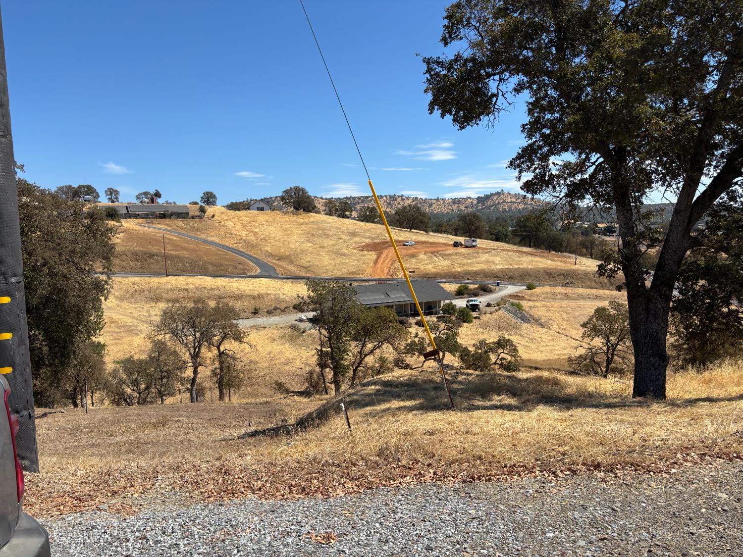 a view of a yard with wooden fence