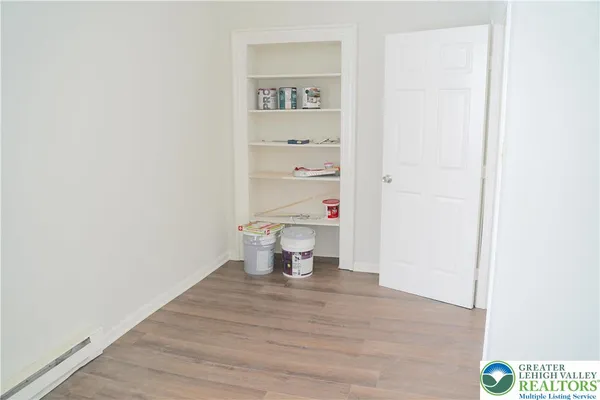 a view of a room with wooden floor and small space