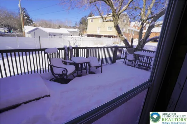 a balcony with table and chairs