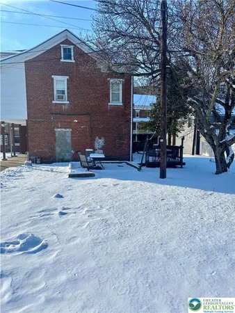 a wooden bench sitting in front of a building