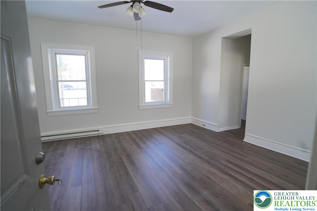 350 Main Street, Unit 5 Slatington, PA 18080 - Photo 3 of 18 an empty room with wooden floor and windows