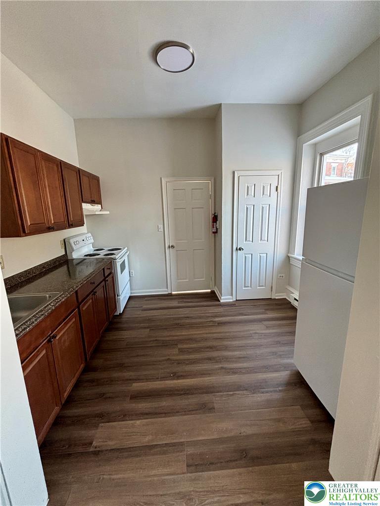 350 Main Street, Unit 5 Slatington, PA 18080 - Photo 6 of 18 a view of a kitchen with wooden floor and electronic appliances