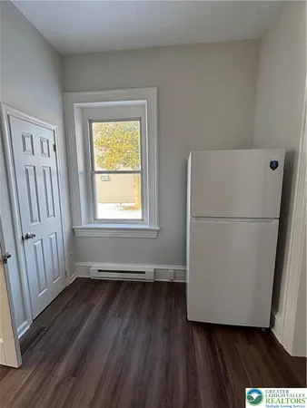 a view of a room with wooden floor and a sink