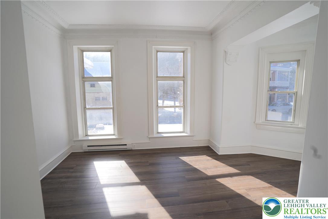 350 Main Street, Unit 5 Slatington, PA 18080 - Photo 9 of 18 an empty room with wooden floor and windows