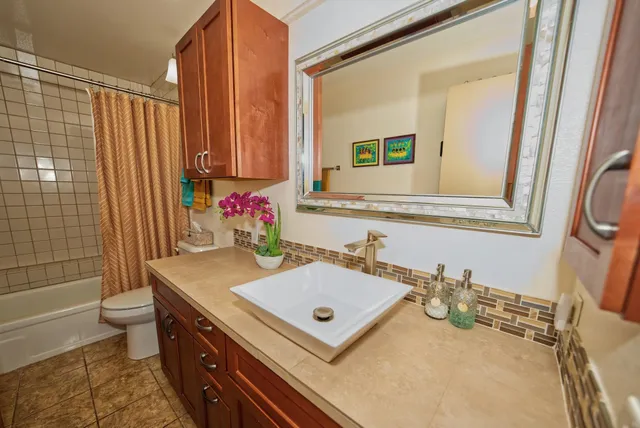a view of a dining room with furniture and a chandelier