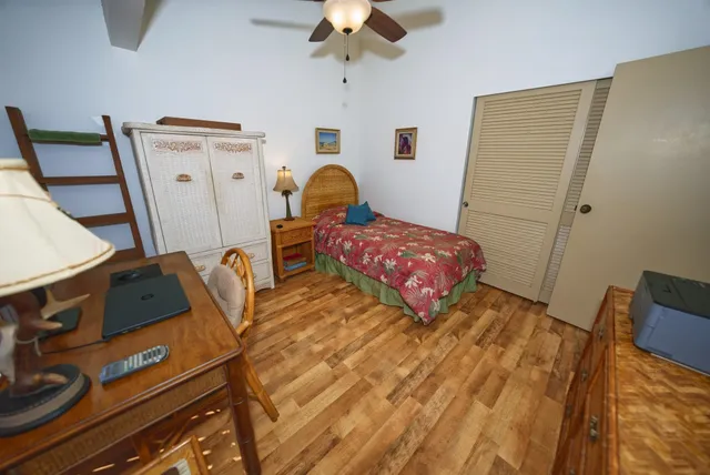 a bedroom with furniture and wooden floor