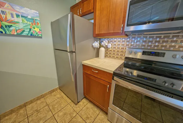 a kitchen with stainless steel appliances granite countertop a stove microwave and sink