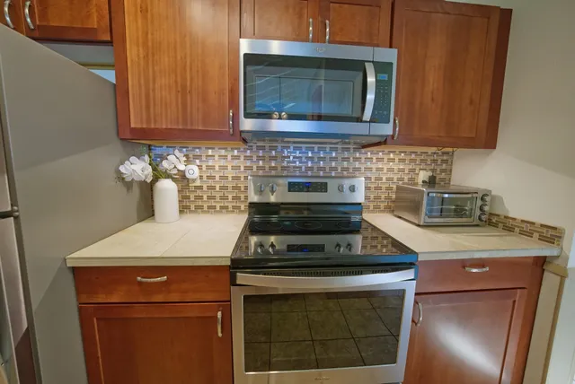 a bedroom with a bed and large windows