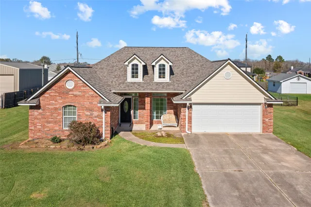 a view of a house with a yard and pathway