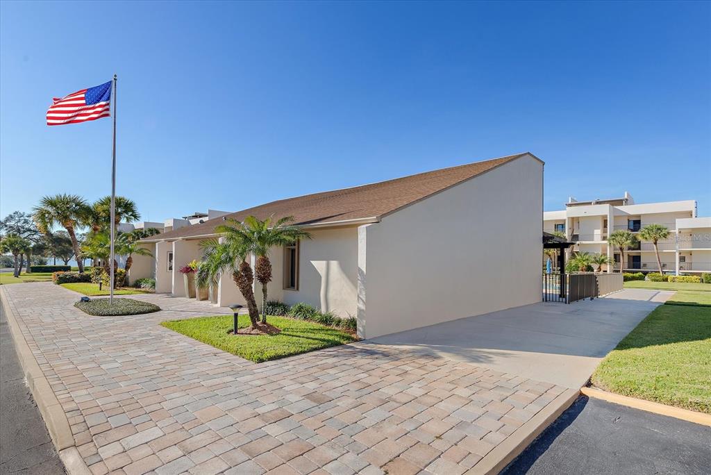 50 Coe Road, Unit 125 Belleair, FL 33756 - Photo 53 of 67 a swimming pool with a yard