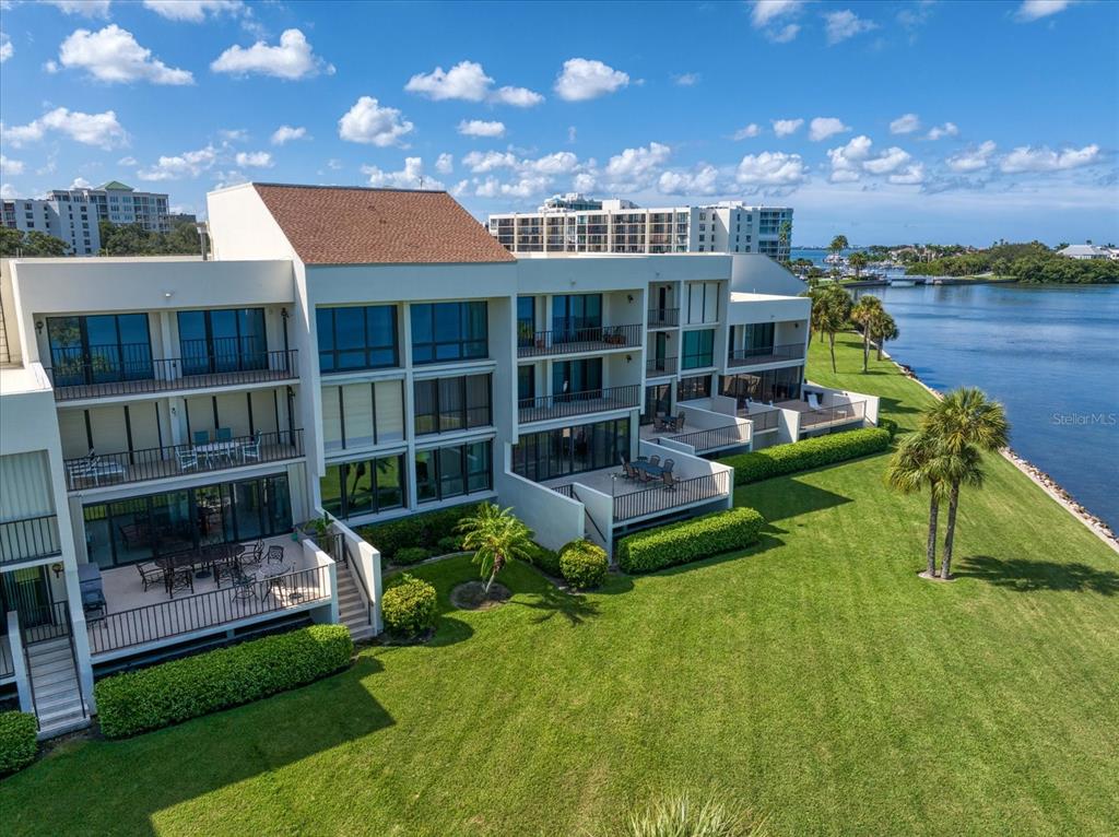 50 Coe Road, Unit 125 Belleair, FL 33756 - Photo 60 of 67 a front view of a house with a yard table and chairs