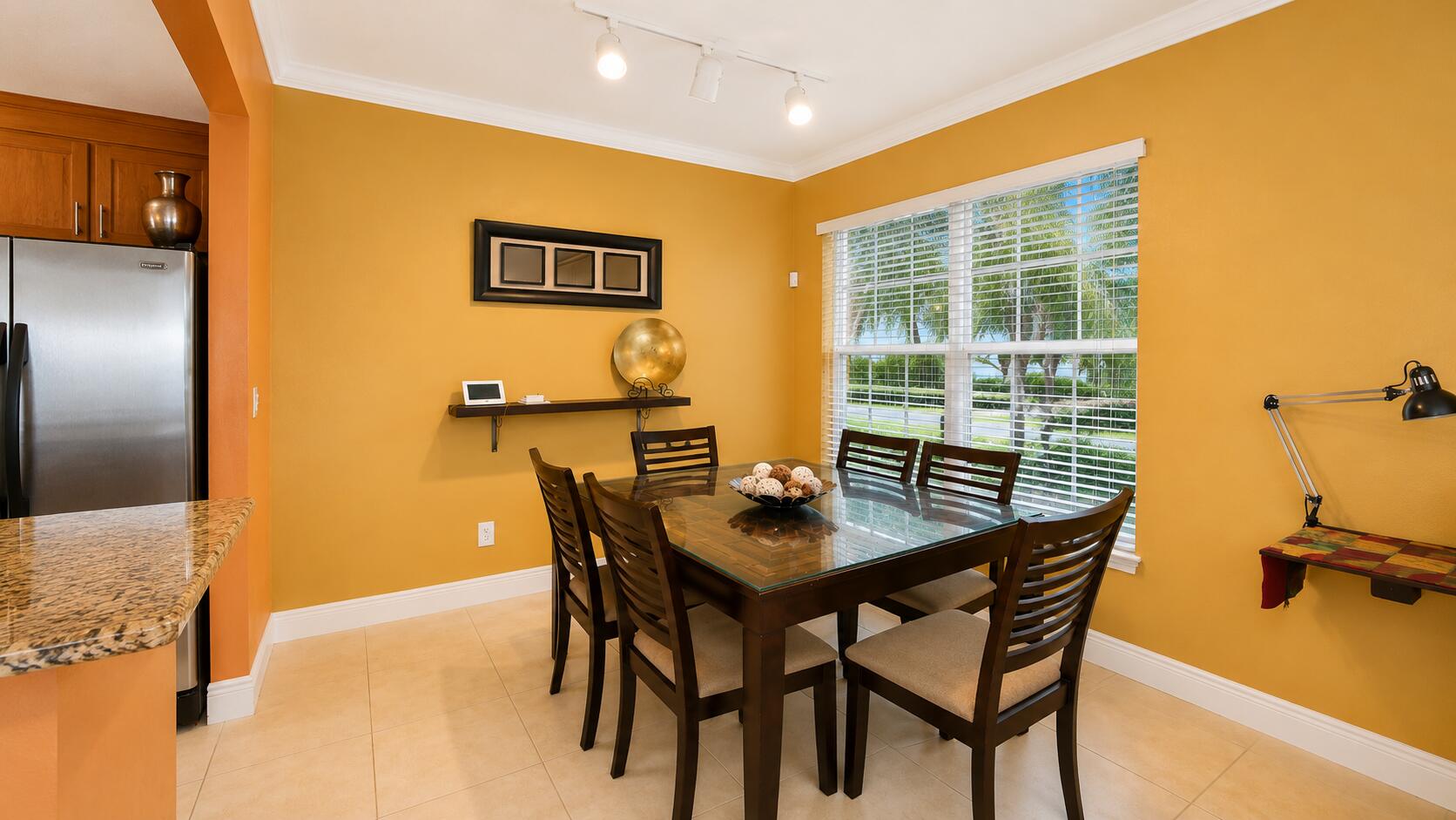 5880 West Sample Road, Unit 105 Coral Springs, FL 33067 - Photo 5 of 17 a view of a dining room with furniture and a table