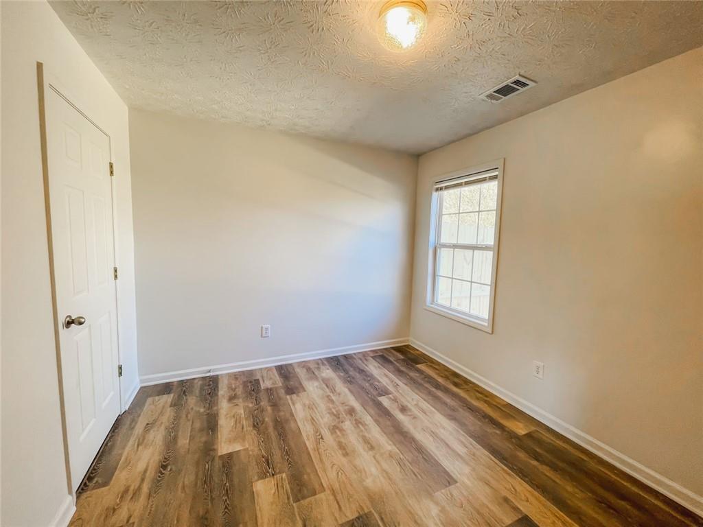 425 Shenandoah Court Winder, GA 30680 - Photo 11 of 17 an empty room with wooden floor and windows