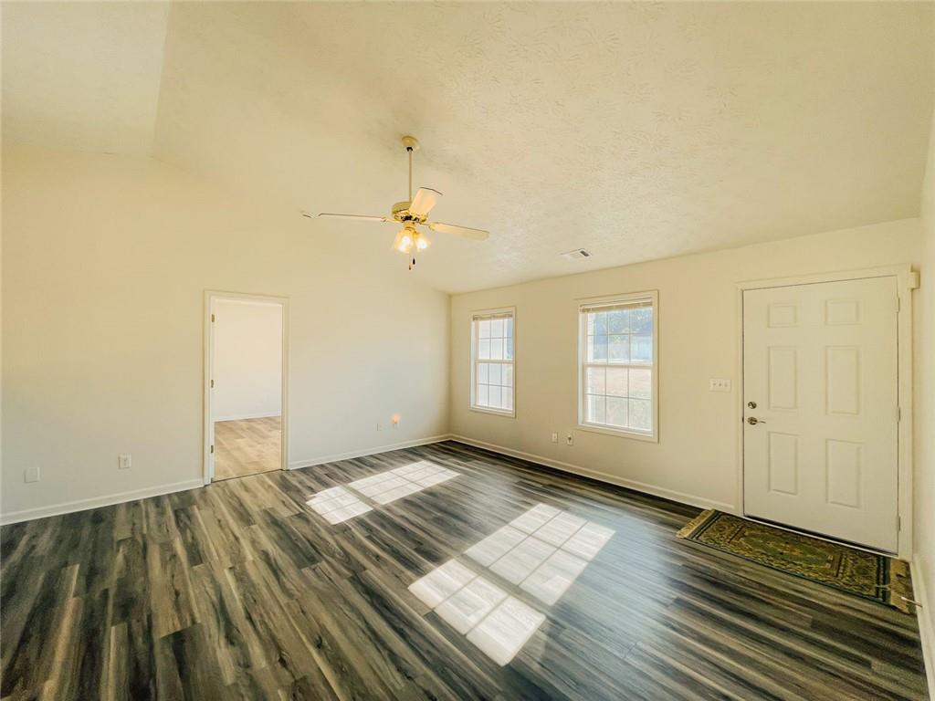 425 Shenandoah Court Winder, GA 30680 - Photo 3 of 17 an empty room with wooden floor and windows