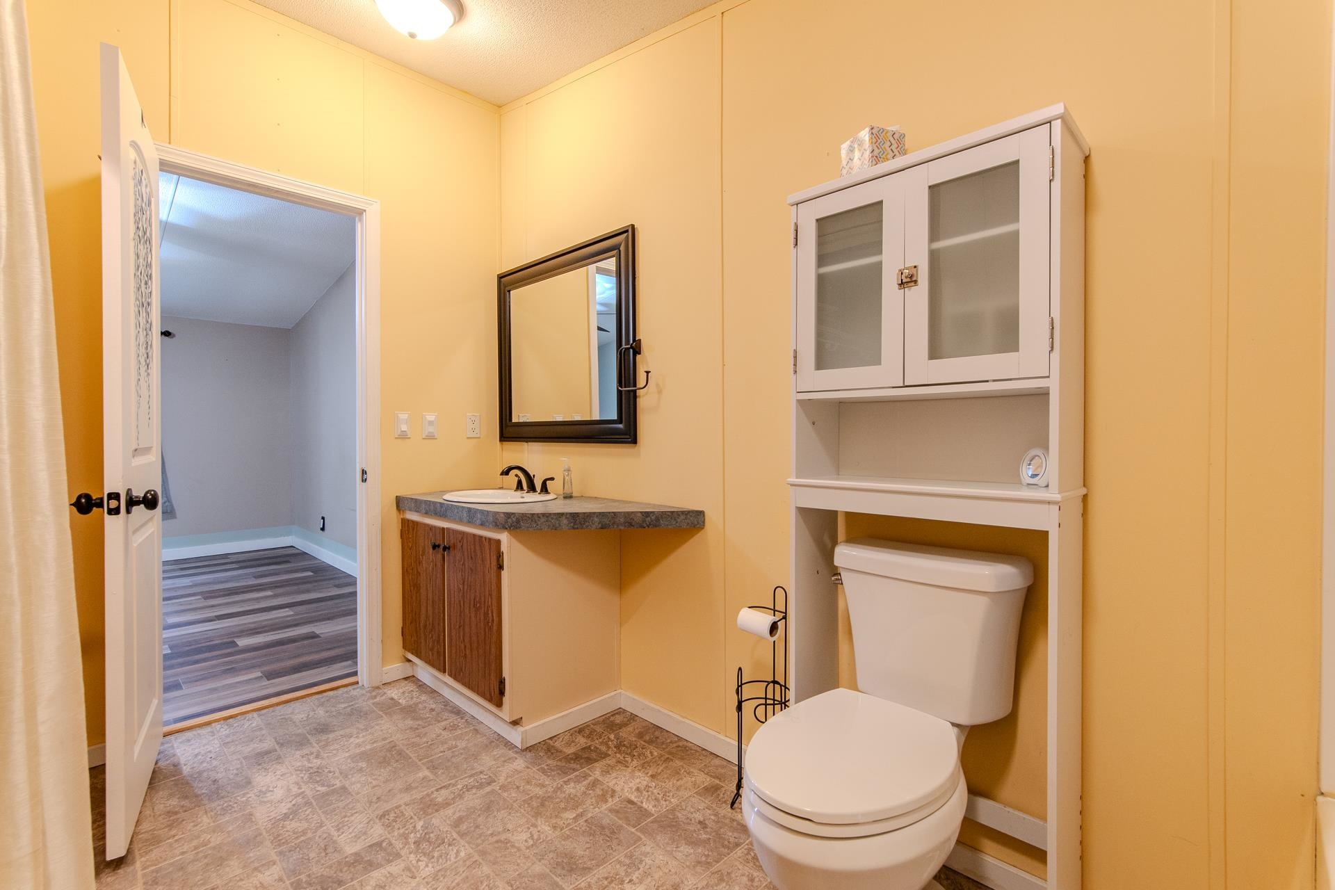 23 Old Ferry Road Bath Springs, TN 38311 - Photo 12 of 40 a spacious bathroom with a toilet sink and mirror