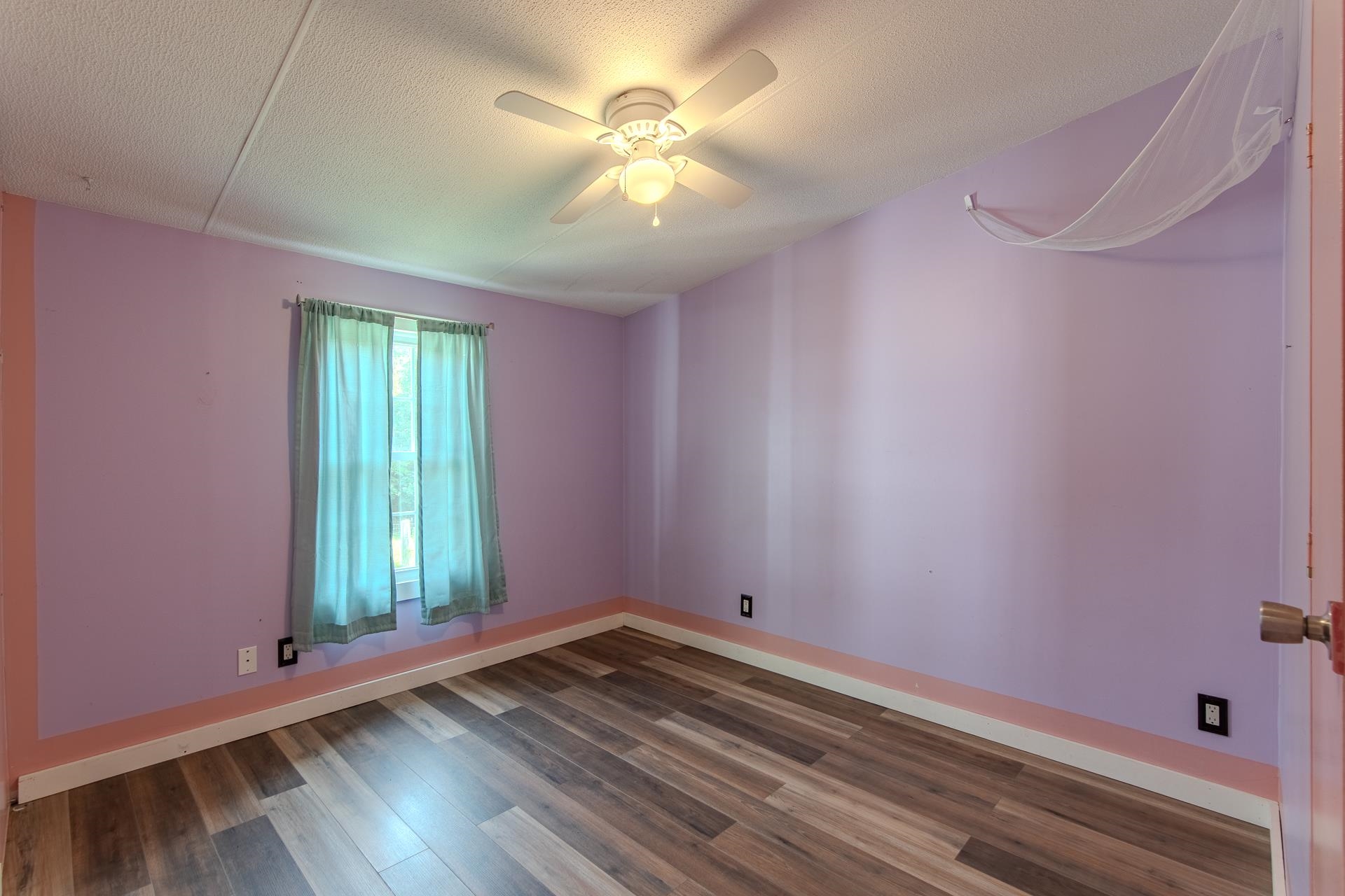 23 Old Ferry Road Bath Springs, TN 38311 - Photo 13 of 40 a view of empty room with window and ceiling fan
