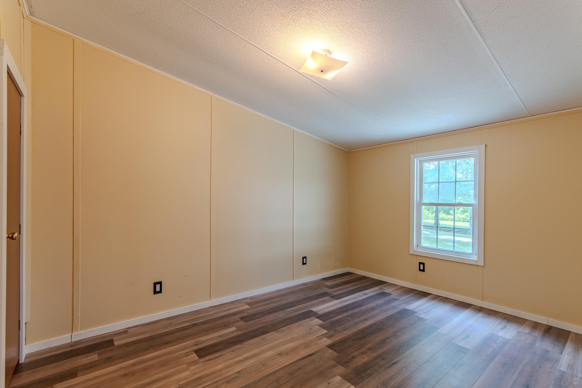 23 Old Ferry Road Bath Springs, TN 38311 - Photo 15 of 40 a view of empty room with wooden floor and fan
