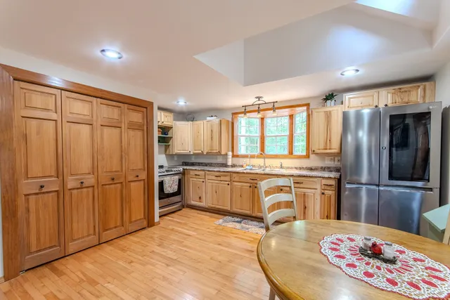 a kitchen with a refrigerator sink and cabinets