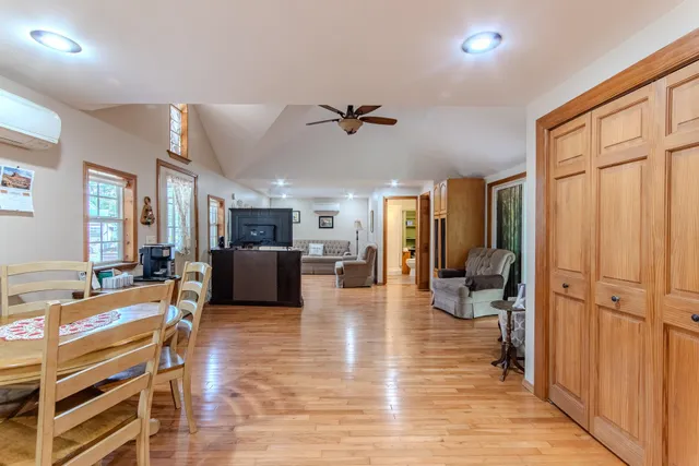 a living room with furniture a ceiling fan and a rug